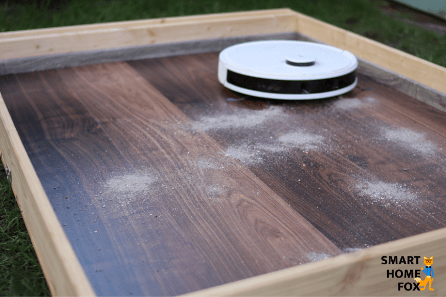 The Ecovacs Deebot  N8+ vacuums sand on a laminate